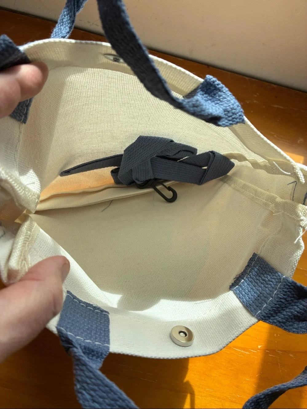 Stitch Canvas Tote in Cream with Blue Stitch Graphic. It’s a Crossbody bag too
